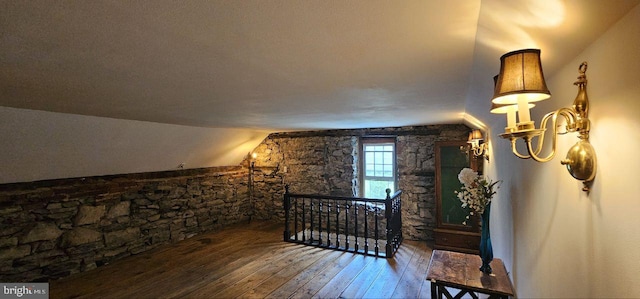 bedroom featuring wood-type flooring and vaulted ceiling