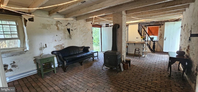 interior space with baseboard heating and a wood stove