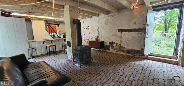 interior space with a wood stove and a healthy amount of sunlight