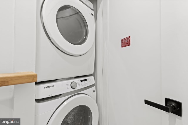 laundry room with stacked washer / drying machine