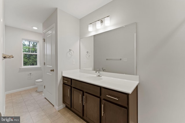 bathroom with vanity, tile patterned floors, and toilet