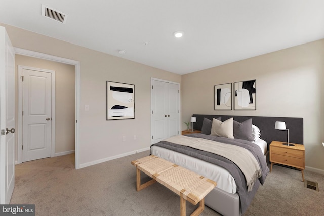 bedroom with light colored carpet and a closet