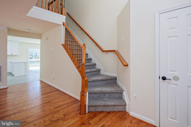 stairway featuring hardwood / wood-style flooring