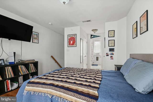 bedroom with hardwood / wood-style floors