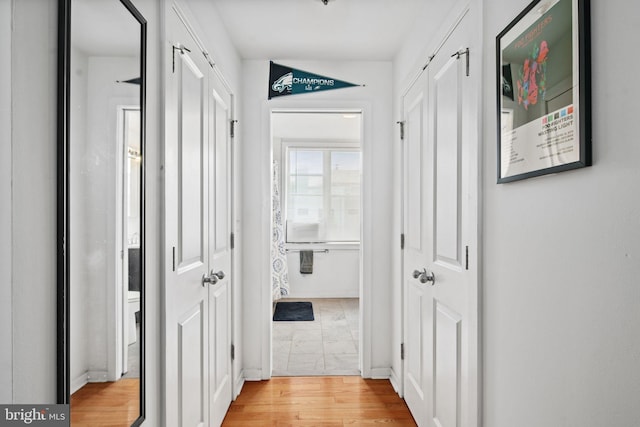 corridor with light hardwood / wood-style flooring