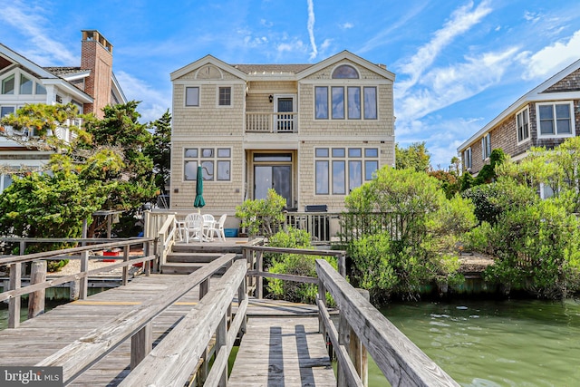 back of house featuring a balcony and a water view