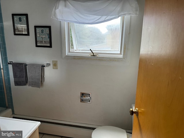 bathroom featuring a baseboard heating unit, vanity, and toilet