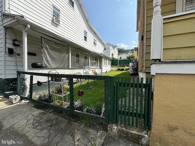 view of gate with a lawn