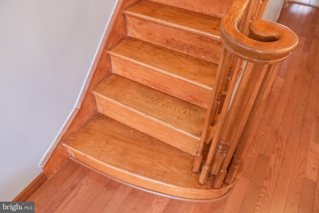 stairway with hardwood / wood-style flooring