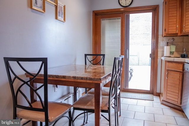 dining area featuring light tile patterned floors and plenty of natural light