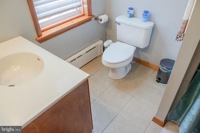 bathroom with a baseboard heating unit, tile patterned floors, toilet, and vanity