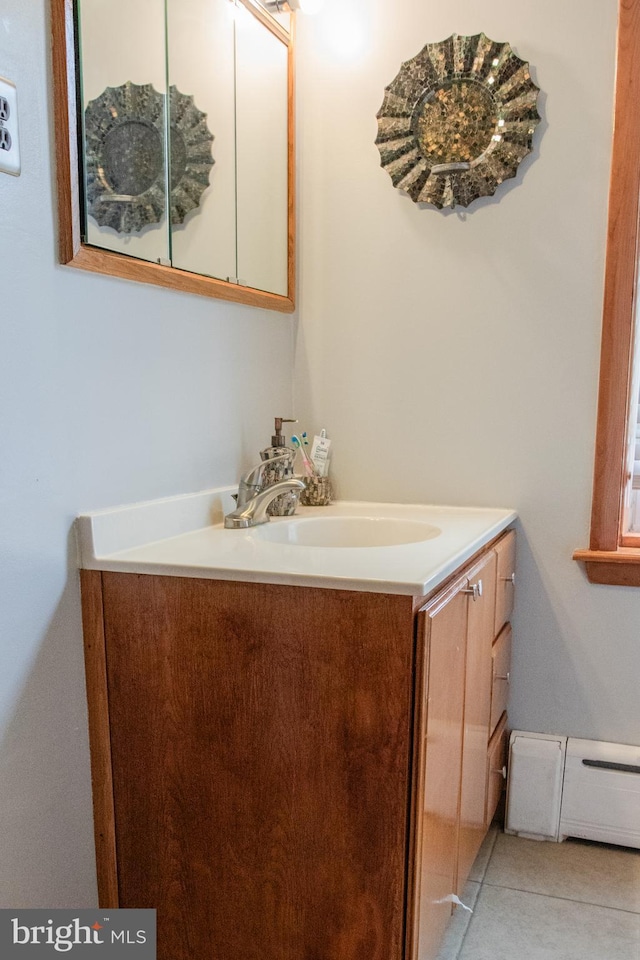 bathroom featuring vanity, baseboard heating, and tile patterned flooring