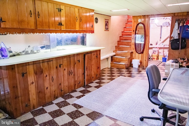 bar with tile patterned flooring and wooden walls