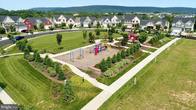 view of home's community with a lawn and a playground