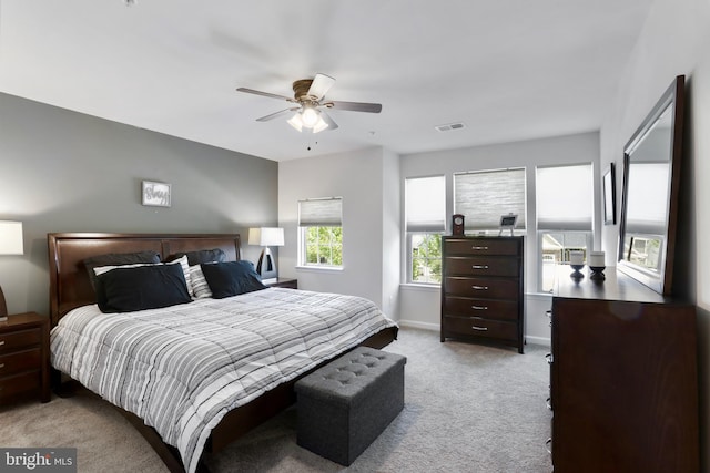 bedroom featuring light carpet and ceiling fan