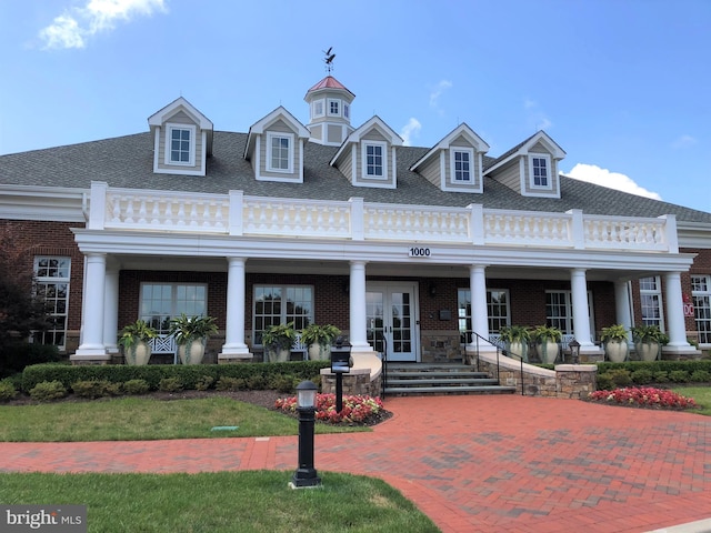 view of front facade featuring french doors and a front yard