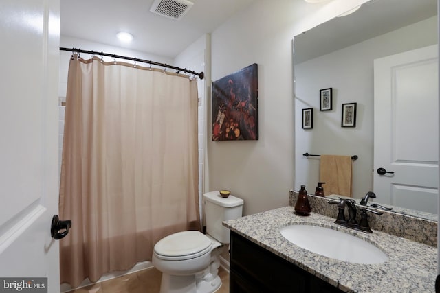 bathroom featuring tile patterned floors, vanity, and toilet