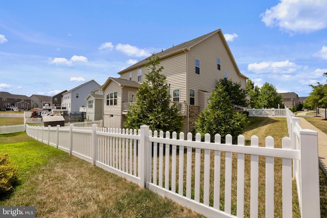 view of side of home with a lawn