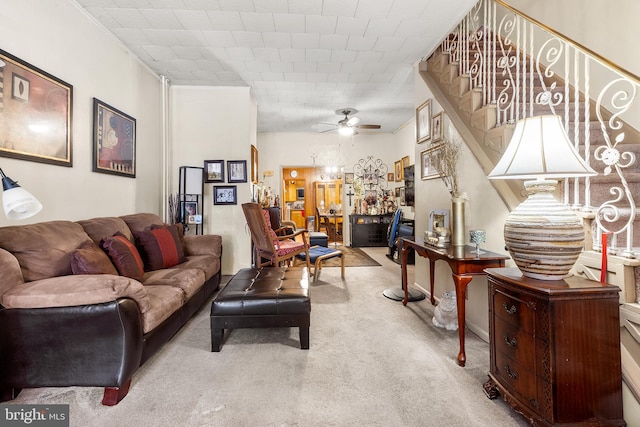 carpeted living room featuring ceiling fan