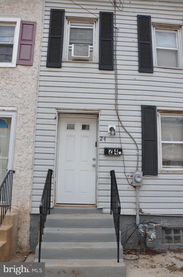 doorway to property featuring cooling unit