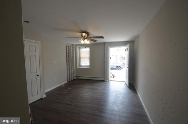 unfurnished room featuring a baseboard radiator, ceiling fan, and wood-type flooring