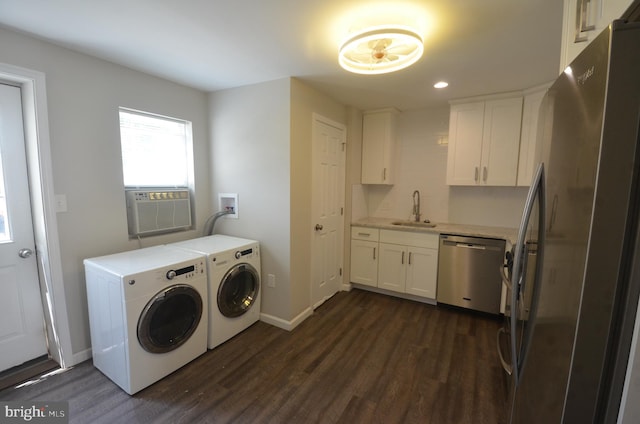 laundry area featuring cooling unit, sink, dark hardwood / wood-style floors, and independent washer and dryer