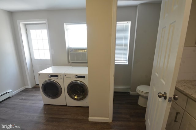 washroom with a baseboard radiator, cooling unit, dark wood-type flooring, and separate washer and dryer