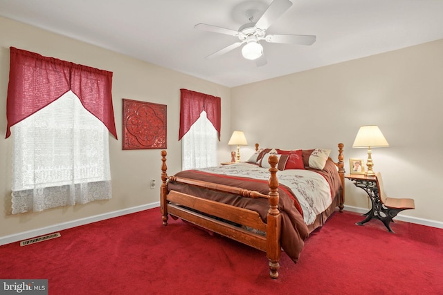 carpeted bedroom featuring multiple windows and ceiling fan