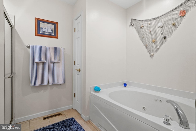 bathroom featuring tile patterned flooring and a bathtub