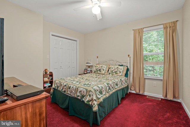 carpeted bedroom with ceiling fan and a closet