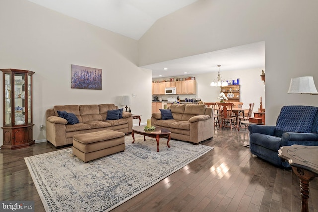 living room with lofted ceiling, dark hardwood / wood-style flooring, and a notable chandelier