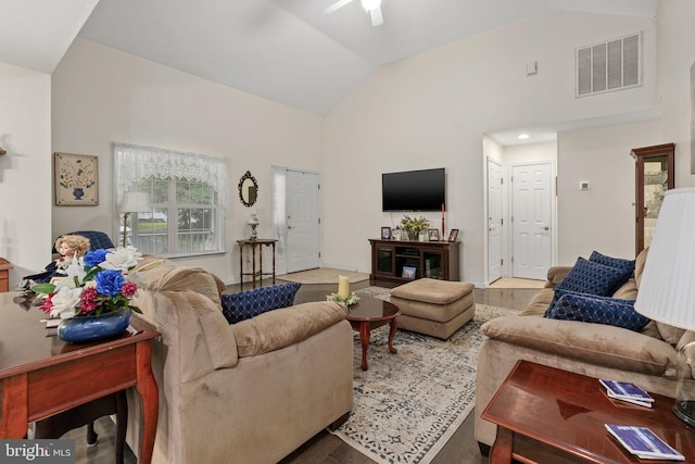 living room featuring lofted ceiling, hardwood / wood-style flooring, and ceiling fan