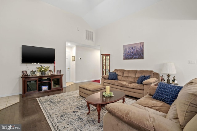 living room with lofted ceiling and dark hardwood / wood-style flooring