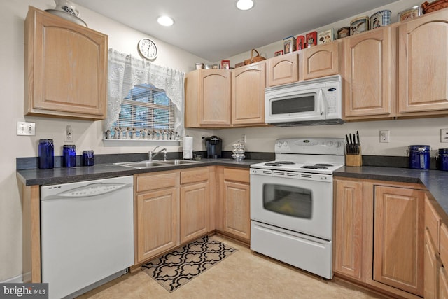 kitchen featuring sink, light brown cabinetry, and white appliances