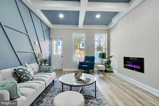 living room featuring beamed ceiling, coffered ceiling, and light hardwood / wood-style floors