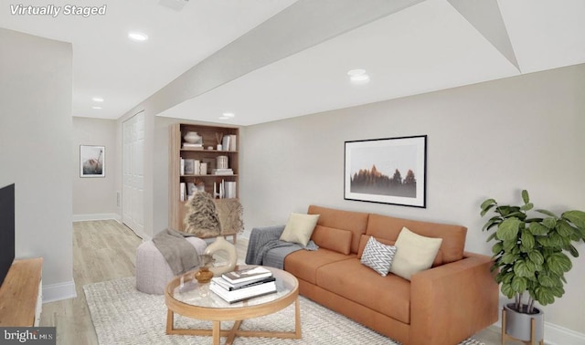 living room with light wood-type flooring, baseboards, and recessed lighting