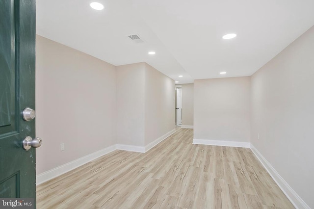 empty room featuring recessed lighting, baseboards, and wood finished floors