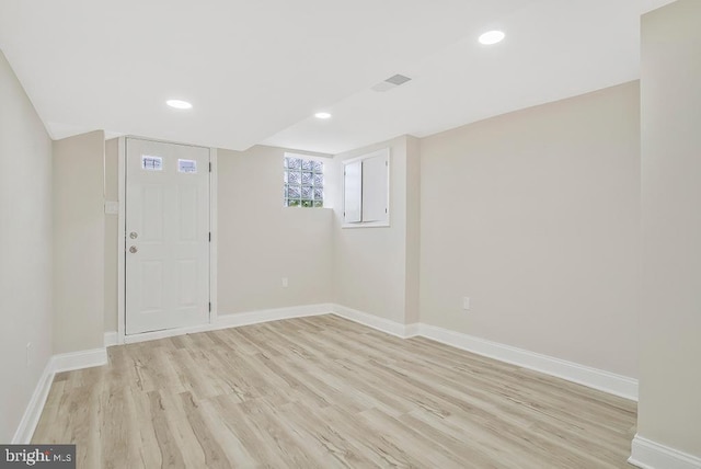 spare room with light wood-style floors, visible vents, baseboards, and recessed lighting