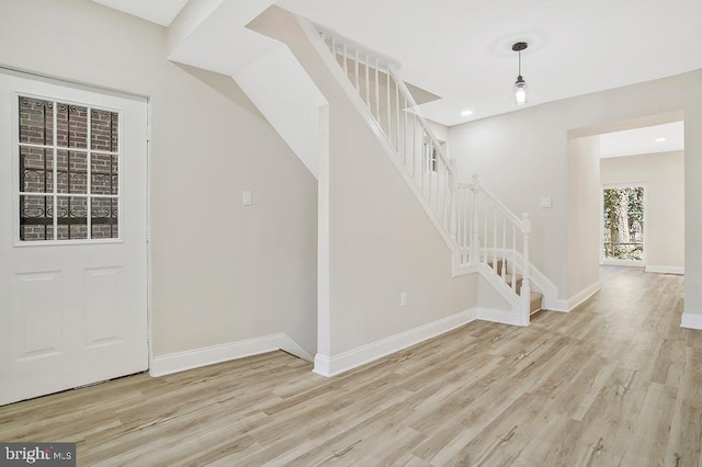 foyer entrance featuring stairs, recessed lighting, baseboards, and wood finished floors