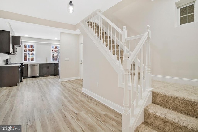 stairway with baseboards and wood finished floors