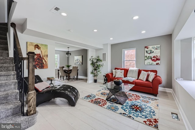 living room with a healthy amount of sunlight and light hardwood / wood-style floors