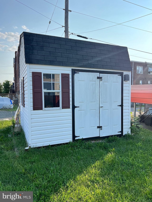 view of outbuilding with a yard