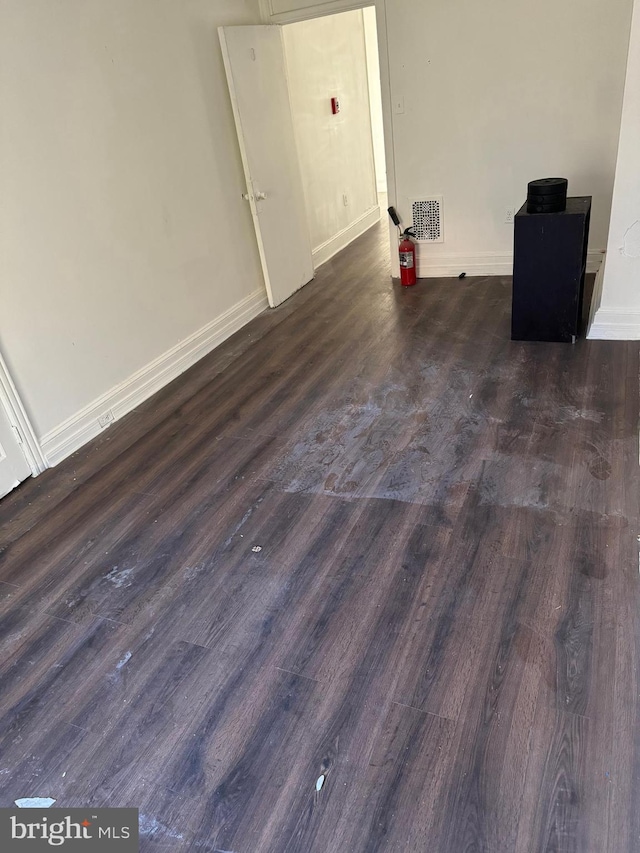 unfurnished room with dark hardwood / wood-style floors