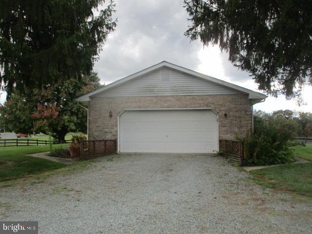 view of home's exterior with a garage and an outbuilding