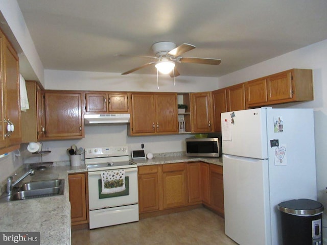 kitchen with white appliances, sink, and ceiling fan