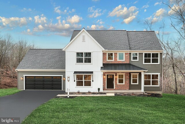 view of front of property with a garage and a front yard