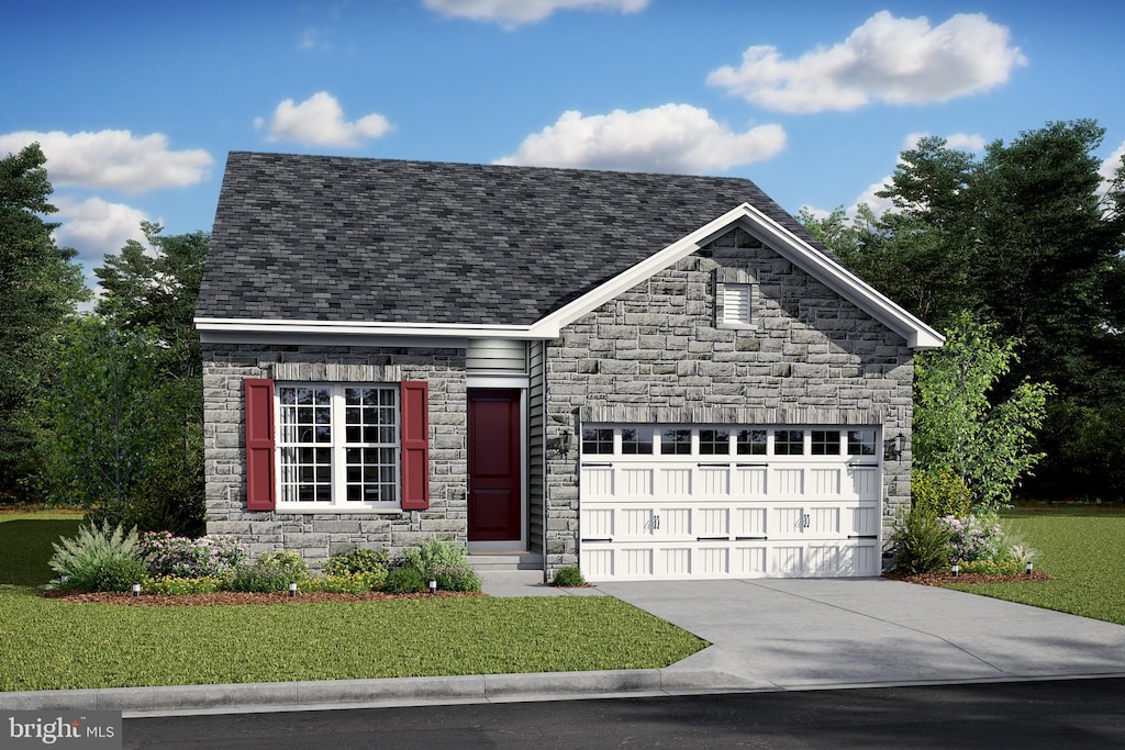 view of front of property featuring a garage and a front yard