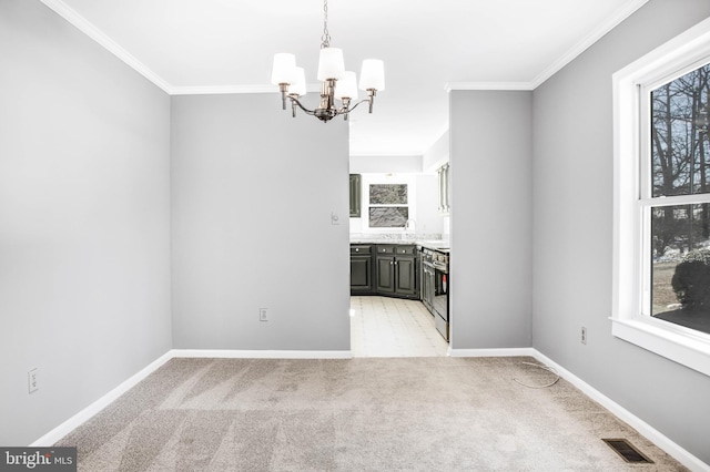 unfurnished dining area with crown molding, a healthy amount of sunlight, and light colored carpet