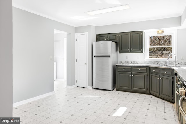 kitchen with crown molding, sink, stainless steel fridge, and light stone counters