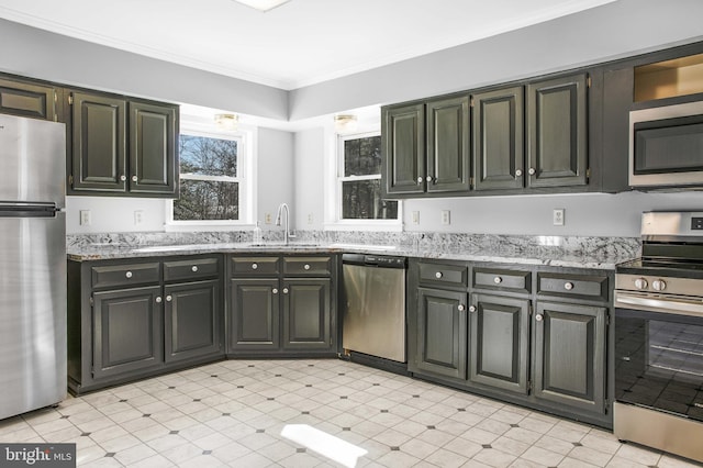 kitchen with crown molding, appliances with stainless steel finishes, sink, and light stone counters